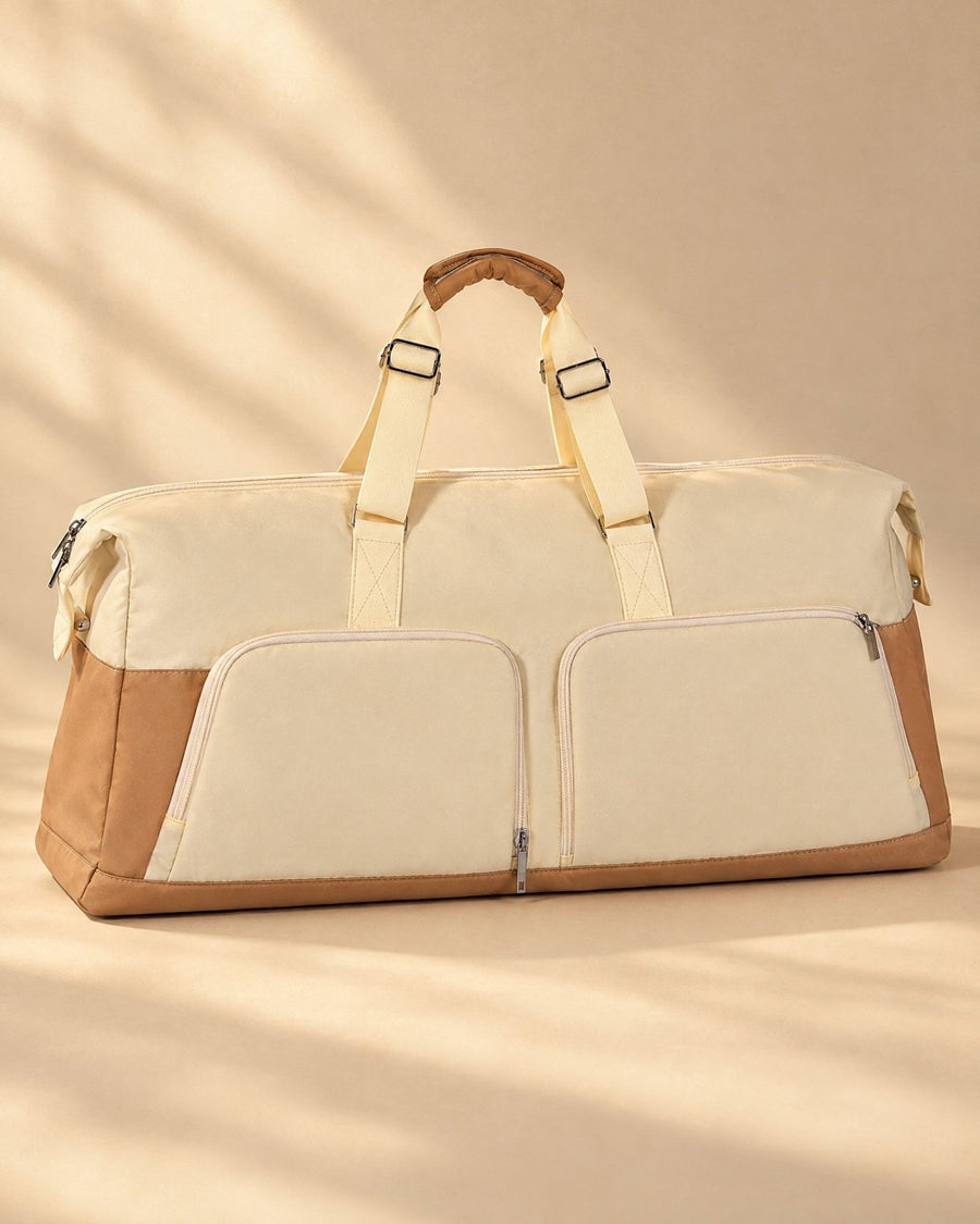 The Costera Duffel in cream with a tan base and two front zip pockets