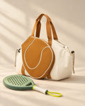 The Hornos Tote in cream with tan trim and a racket-head-shaped front pocket