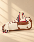 The Quebrada Racket Bag in cream with tan trim and striped handles