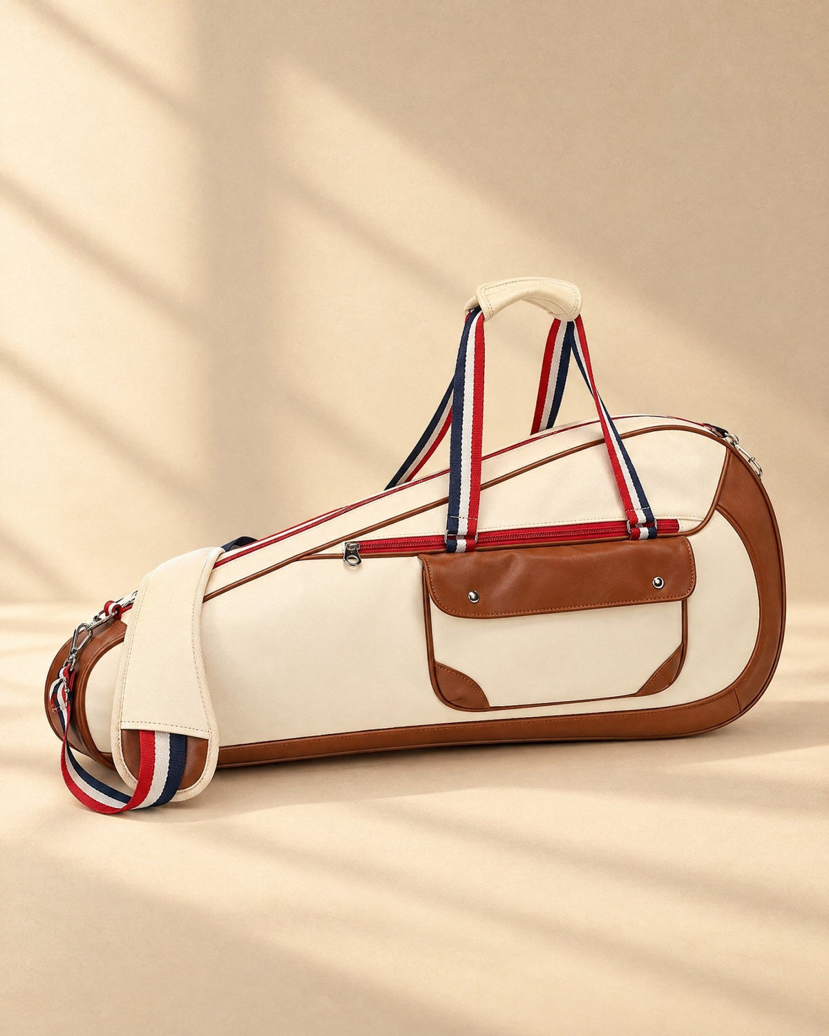 The Quebrada Racket Bag in cream with tan trim and striped handles