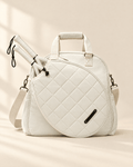 The Las Brisas Racket Bag in white, with two padel rackets in the quilted front compartment